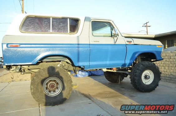 Side view of a lifted 1979 Ford Bronco with blue and white paint