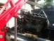 1993 Ford Bronco - An engine is suspended by chains and a red engine hoist, being removed from a vehicle.