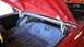 1964 Ford Fairlane - The interior of a car's trunk is shown with the lid open.