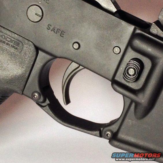 Close-up of a firearm's trigger and safety selector mechanism