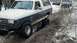 1989 Ford Bronco - This 1989 Ford Bronco is navigating a snowy, muddy trail with other vehicles in the background.