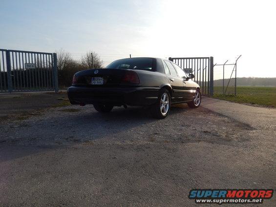 Black 2003 Mercury Marauder rear view parked by a gate