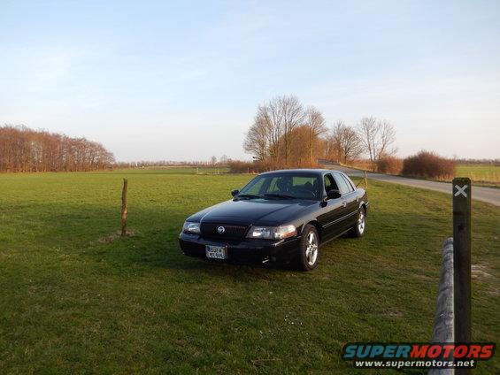 2003 Mercury Marauder parked on a grassy field next to a road