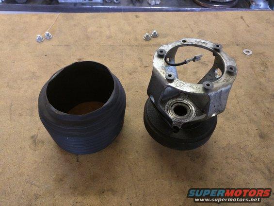 Automotive part with a rubber bellows and a metal hub assembly with wires