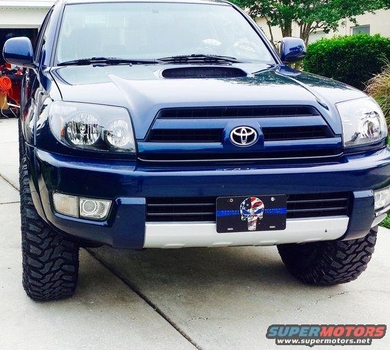 Blue 2005 Toyota 4Runner front view with aftermarket tires and a custom license plate
