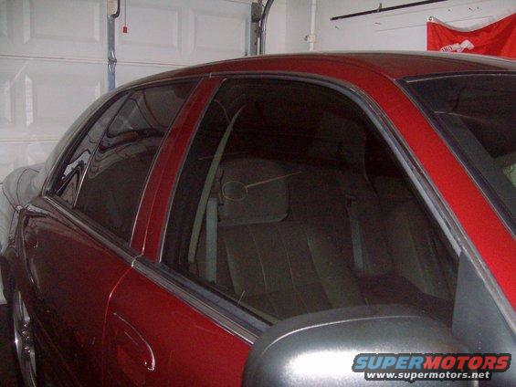 2004 Ford Crown Victoria side view showing tinted windows and interior