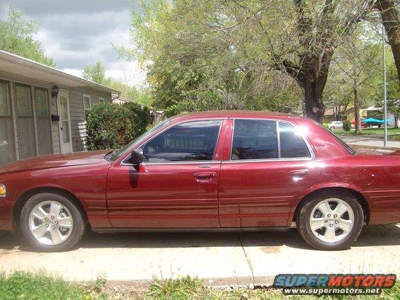 Red 2004 Ford Crown Victoria sedan, side view