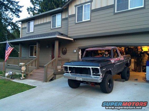 1978 Ford Bronco parked in driveway, front end visible, person in driver's seat. License plate reads 29F9502