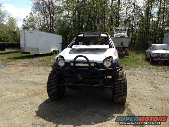 Modified off-road vehicle with large tires and a bull bar