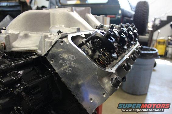 Close-up of a V8 engine block and valve cover labeled "Super Cobra Jet"