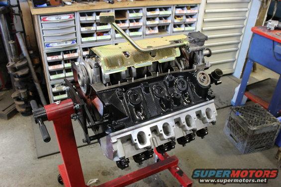 Engine on red stand, black block, yellow cover