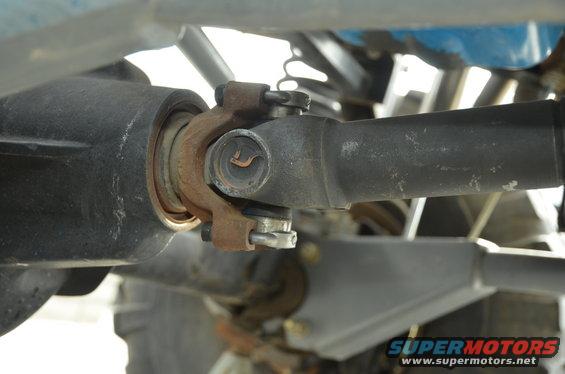 Close-up of a driveshaft U-joint connection with rust
