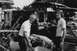 1968 Mercury Cougar - Three people examine a severely damaged vehicle in what appears to be a junkyard or salvage yard.
