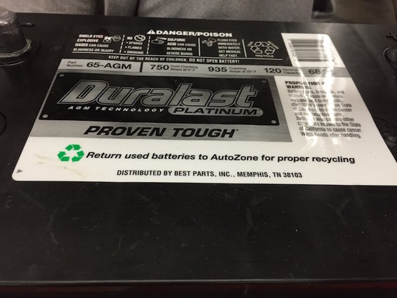 Duralast Platinum AGM battery with recycling symbol and "Proven Tough" text