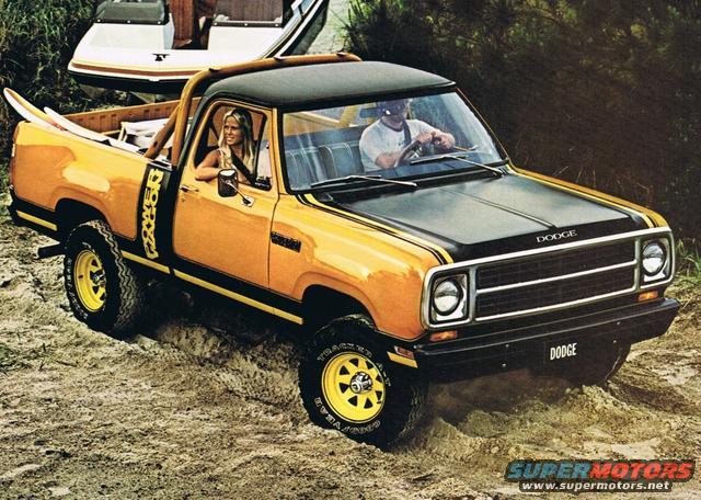 Yellow and black Dodge pickup truck with yellow wheels and black racing stripes, driving on a dirt path