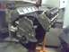 1985 Ford Bronco - V8 engine block with valve covers and timing cover visible, mounted on an engine stand.