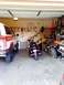 1985 Ford Bronco - A garage contains a red and white SUV, a cruiser motorcycle, and a dirt bike, along with various stored items.