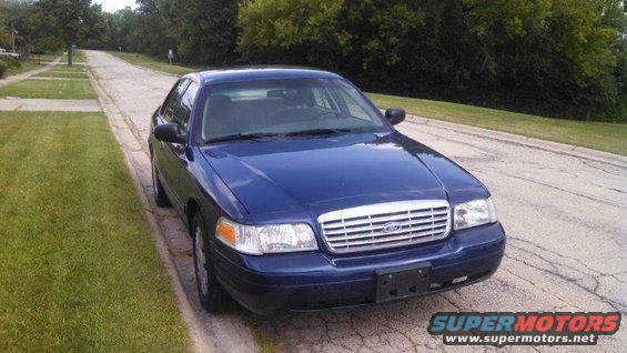 Blue 2006 Ford Crown Victoria parked on a residential street