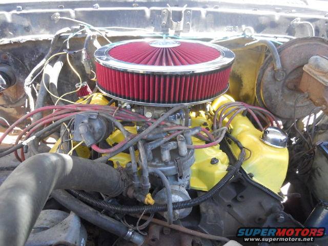 Engine bay with yellow valve covers, red air filter, and visible wiring