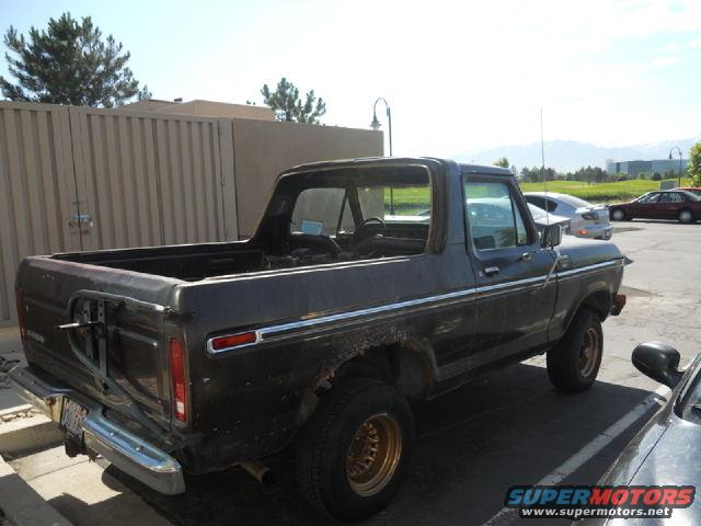 1979 Ford Bronco, dark color, rear quarter view with spare tire carrier