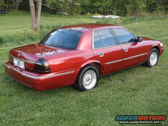 Red 1999 Mercury Grand Marquis, rear 3/4 view