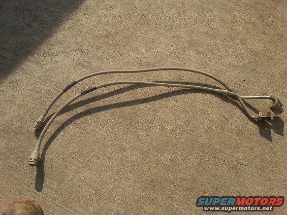 two metal brake lines with connectors