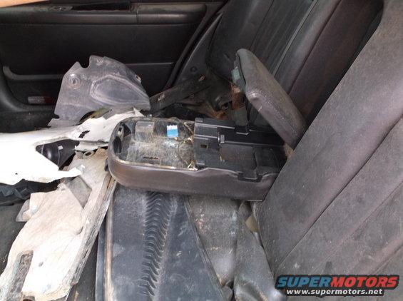 Car interior with disassembled center console and torn upholstery