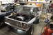 1979 Ford Bronco - A Ford Bronco is in a garage with its hood open, revealing the engine, with another vehicle partially visible behind it.