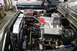 1979 Ford Bronco - Custom Ford V8 engine build with racing valve covers and headers. Another vehicle is visible in the background.