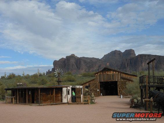 Western town with wooden buildings and mountains in the background
