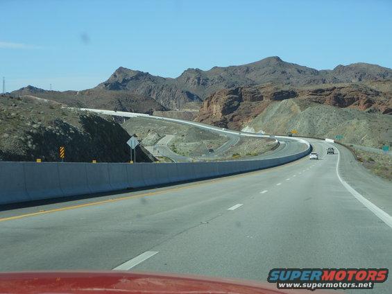 Highway scene with mountains and cars on the road