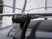 1964 Volkswagen Beetle - Thule roof rack clamp attached to the roof of a vehicle.