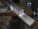 1992 Ford Bronco - Metal part being machined on a milling machine with a magnetic base indicator.