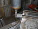 1992 Ford Bronco - A milling machine is actively cutting a metal component, with metal shavings visible on the machine bed.