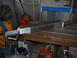 1992 Ford Bronco - A custom machined metal part rests on a workbench in a workshop setting.