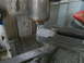 1992 Ford Bronco - A milling machine is actively cutting a metal component, creating shavings.