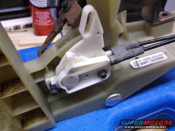 Gear shifter assembly with white plastic components and metal linkage. Label reads '12/22/2006'