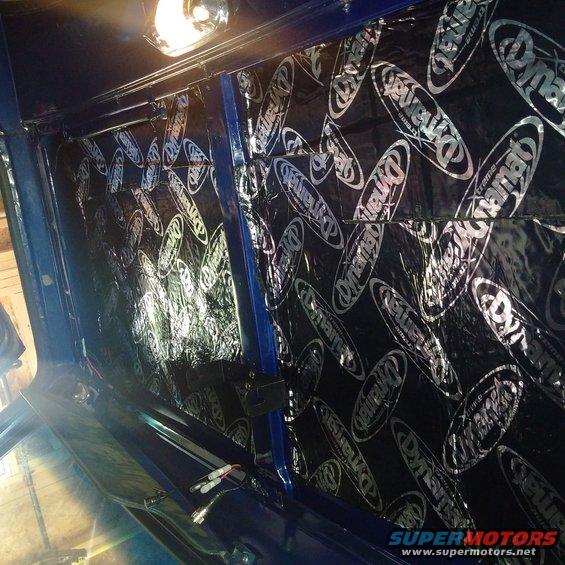 Interior view of Dynamat sound deadening material on a blue vehicle's wall