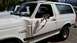 1990 Ford Bronco - This white Ford Bronco has significant damage to its front passenger side fender and door.