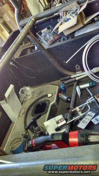 Vehicle interior with fuel tank, fuel pump, and tools