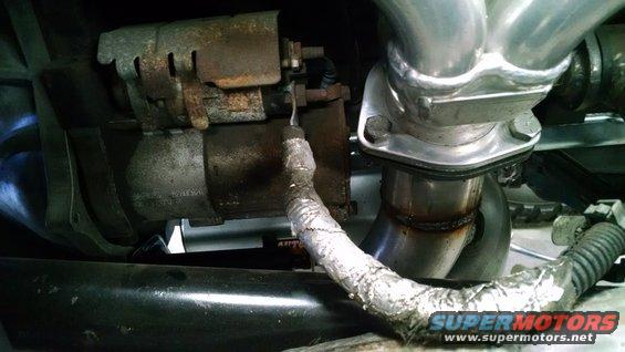 Starter motor and exhaust manifold with heat wrap