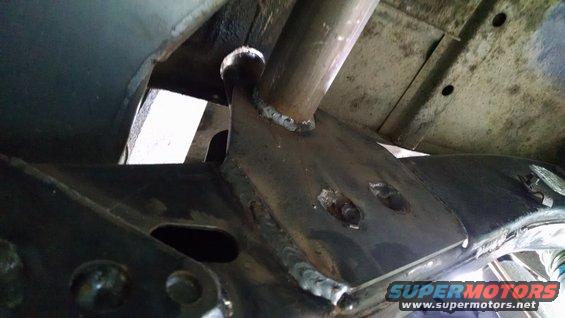 Close-up of welded metal brackets and tubing on a vehicle frame