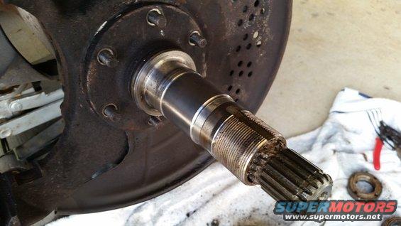 Vehicle axle with splines and brake rotor assembly on a white towel