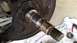 1990 Ford Bronco - Close-up of a vehicle's axle and brake rotor assembly, resting on a towel.