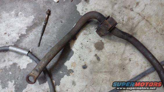 rusted metal bar and a bolt on a concrete floor