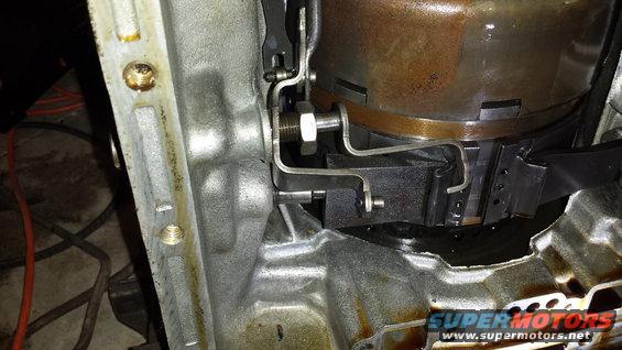 Close-up of internal transmission components, showing metal casing, linkages, and a rotating drum