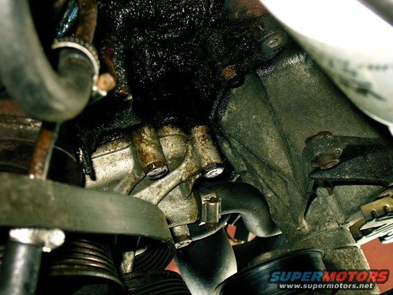 Engine component with heavy oil buildup and visible leaks