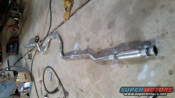 Exhaust system pipe laid out on concrete floor