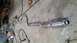 1985 Ford Escort - Exhaust system pipe on concrete floor, possibly for a car or truck.