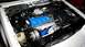 1985 Ford Escort - Close-up view of a car's engine bay, showing various components and wiring.